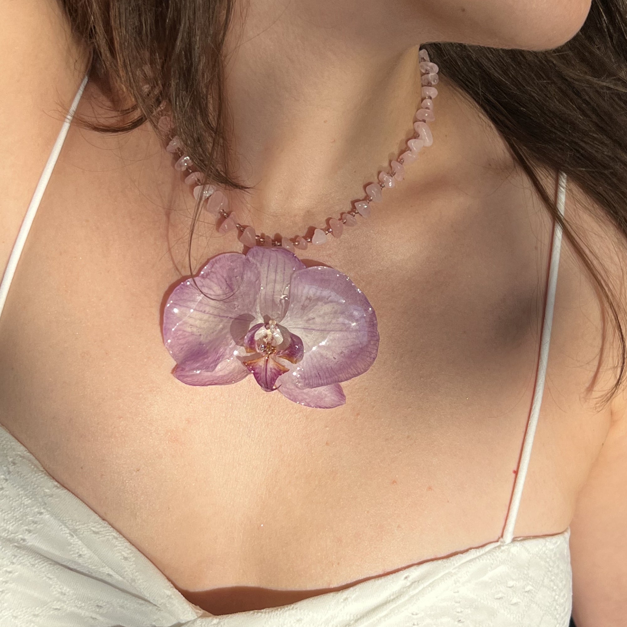 Handmade Necklace with pink beads and a natural light purple orchid flower as pendant.