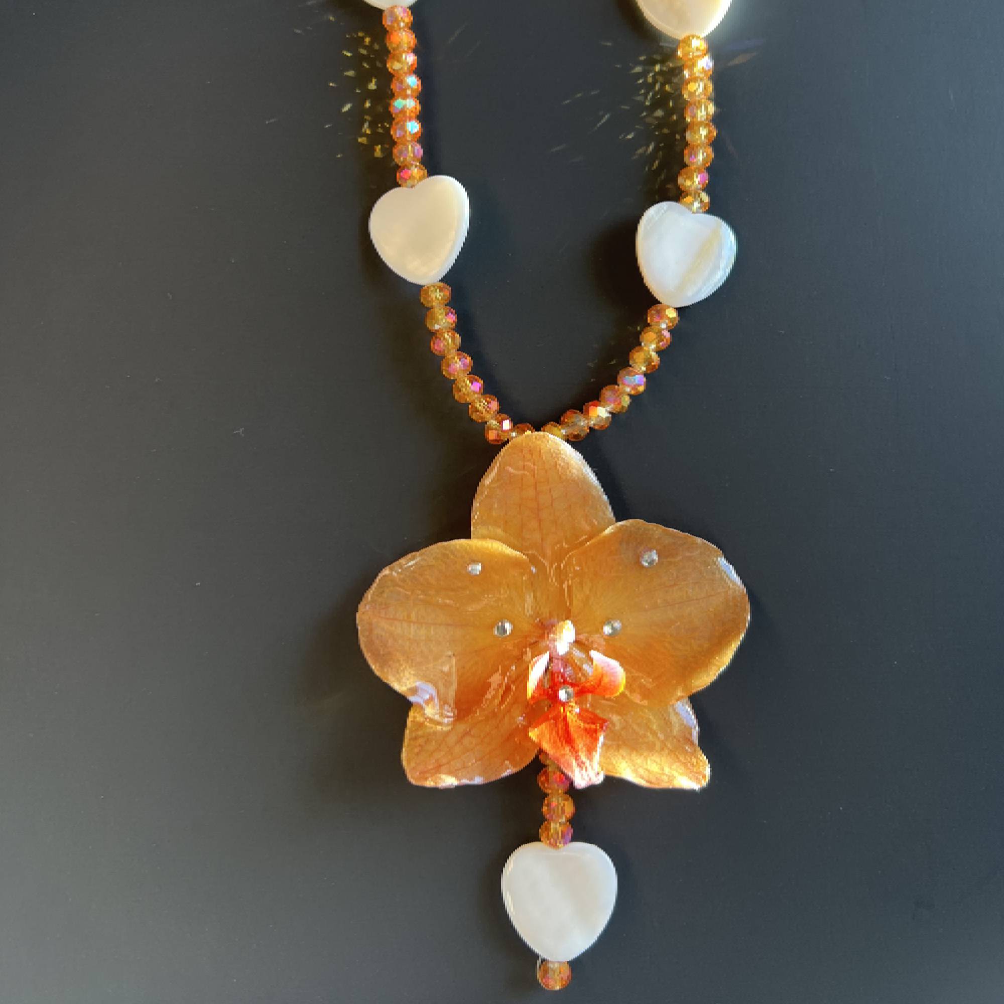 Real orange orchid flower necklace, handmade with resin-preserved tropical bloom. Features natural heart seashells and glass beads. Unique floral pendant jewelry, beach-inspired gift for her, botanical statement necklace, eco-friendly nature accessory, boho summer jewelry, one-of-a-kind artisan gift.